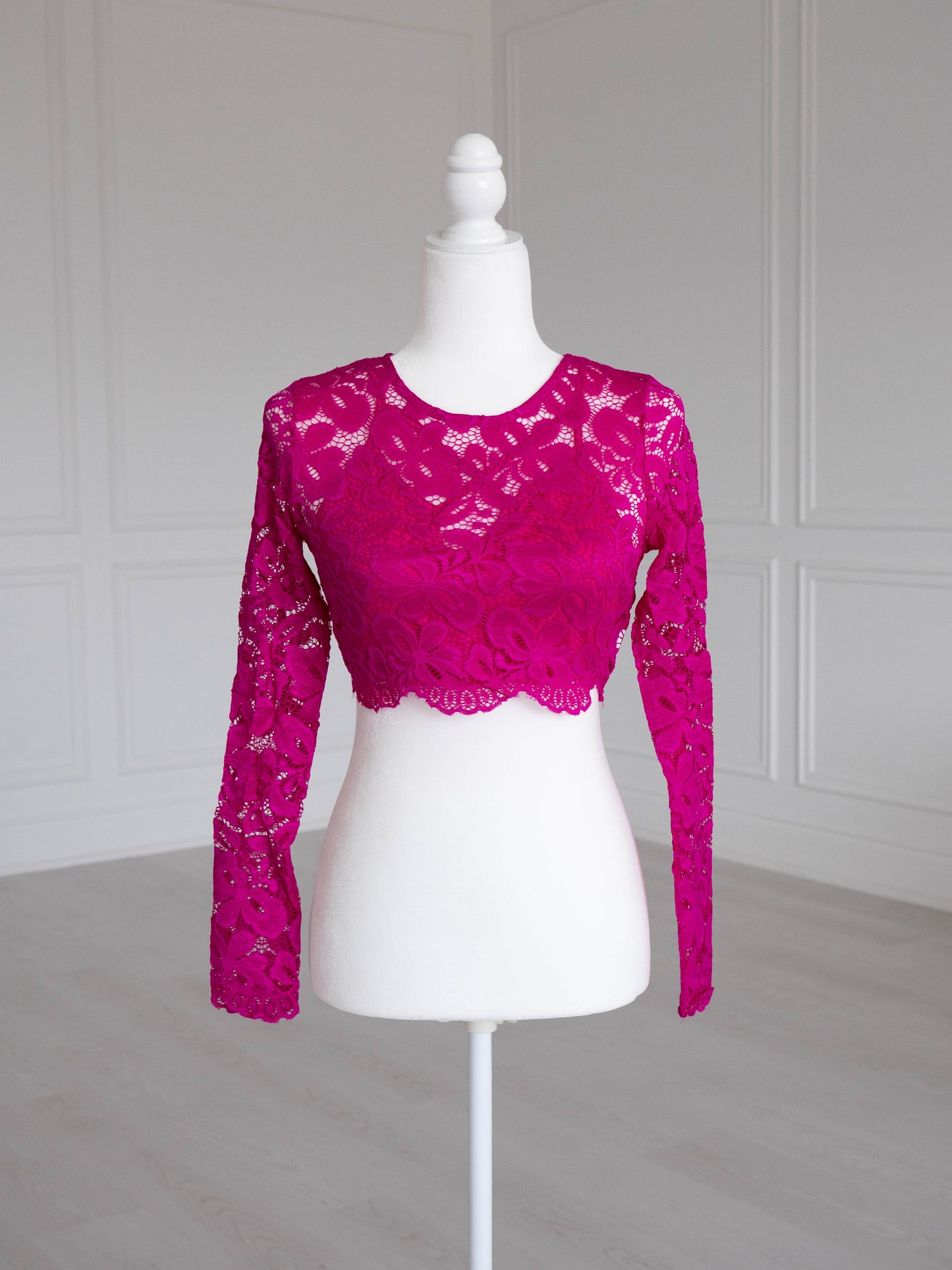 Hot Pink Lace Crop Top with floral pattern, scalloped edges and sheer sleeves, designed to pair with sarees or lehengas. Readymade, fully lined body with reversible neckline.