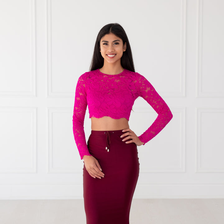 Hot Pink Lace Crop Top with floral pattern, scalloped edges and sheer sleeves, designed to pair with sarees or lehengas. Readymade, fully lined body with reversible neckline.
